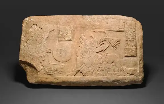 Limestone panel depicting Maya ballplayers and hieroglyphs.