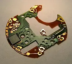 The electronic circuit board of a quartz chronograph watch.
