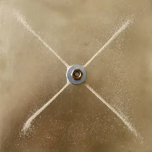 A Chladni pattern formed by particles on a vibrating plate.