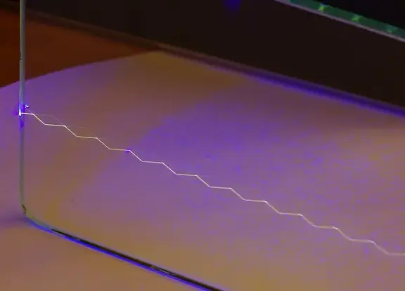 A laser beam repeatedly reflecting inside a glass plate.