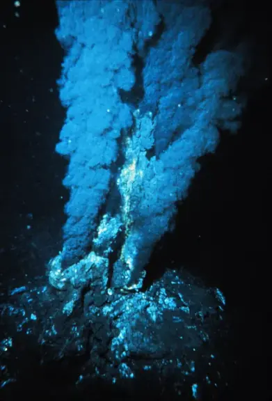 A deep-sea black smoker releasing a plume of mineral-rich fluid.