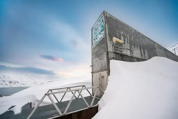 The entrance to the Svalbard Global Seed Vault in a snowy landscape.