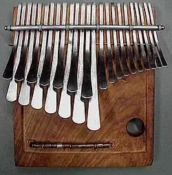 An mbira with metal keys fixed to a wooden soundboard.