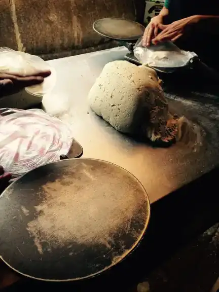 Corn masa dough being prepared for tortillas.